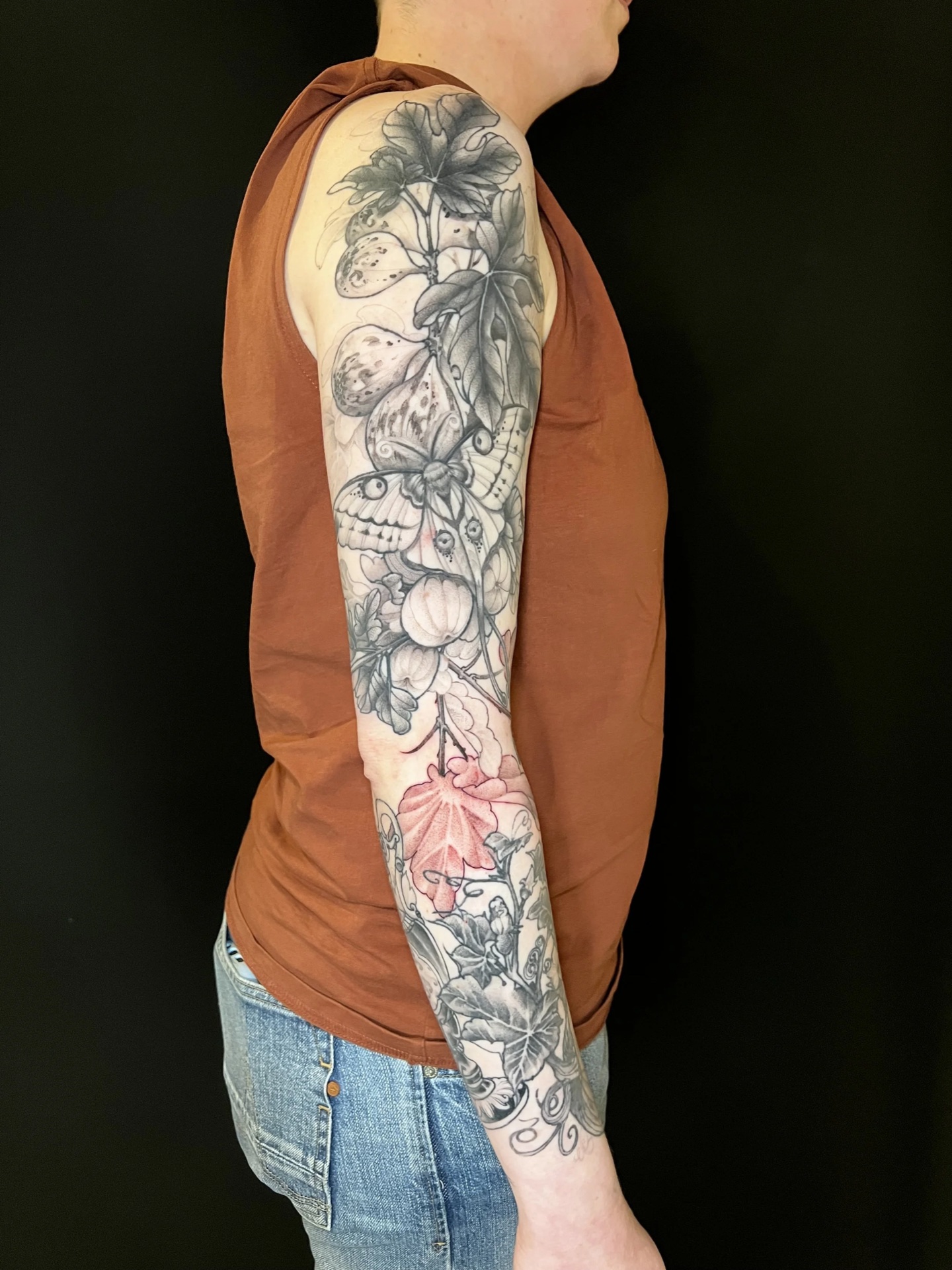 Black and grey botanical fine-line sleeve tattoo by Levi Taylor