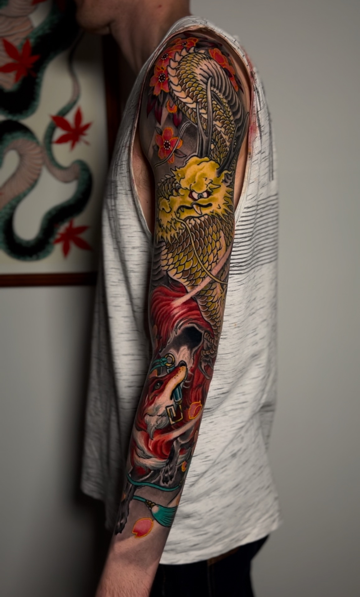 Golden dragon and fox colour sleeve tattoo by Levi Taylor