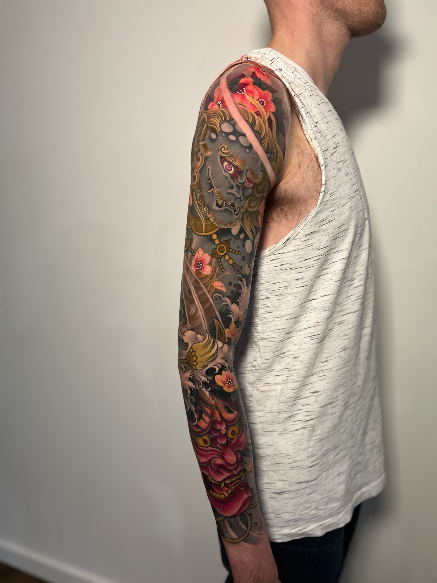 Hannya mask and foo dog colour sleeve tattoo by Levi Taylor